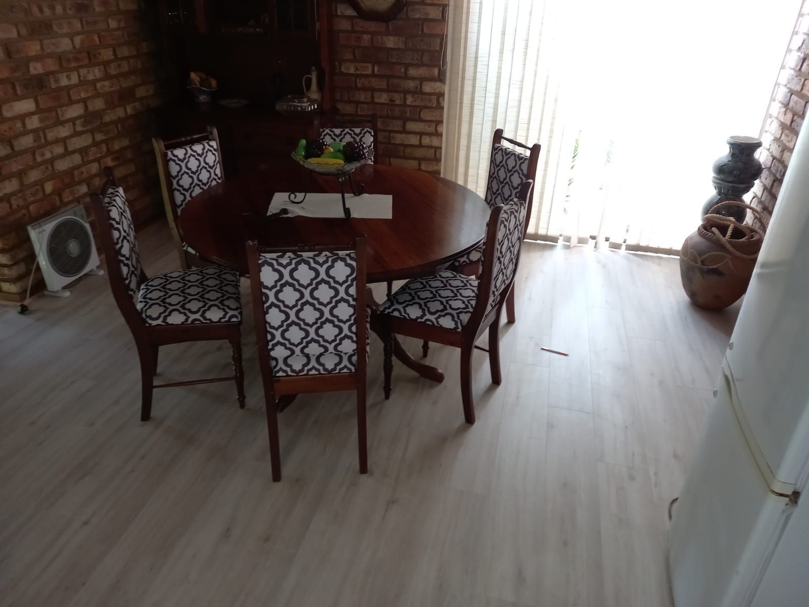 A dining room with a round table and chairs