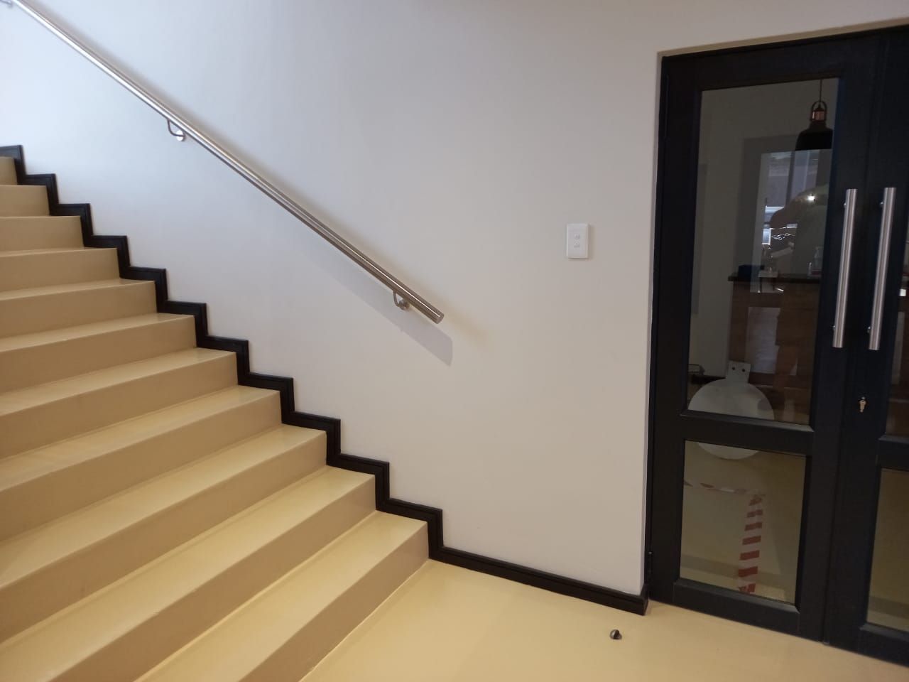 A set of stairs leading up to a glass door