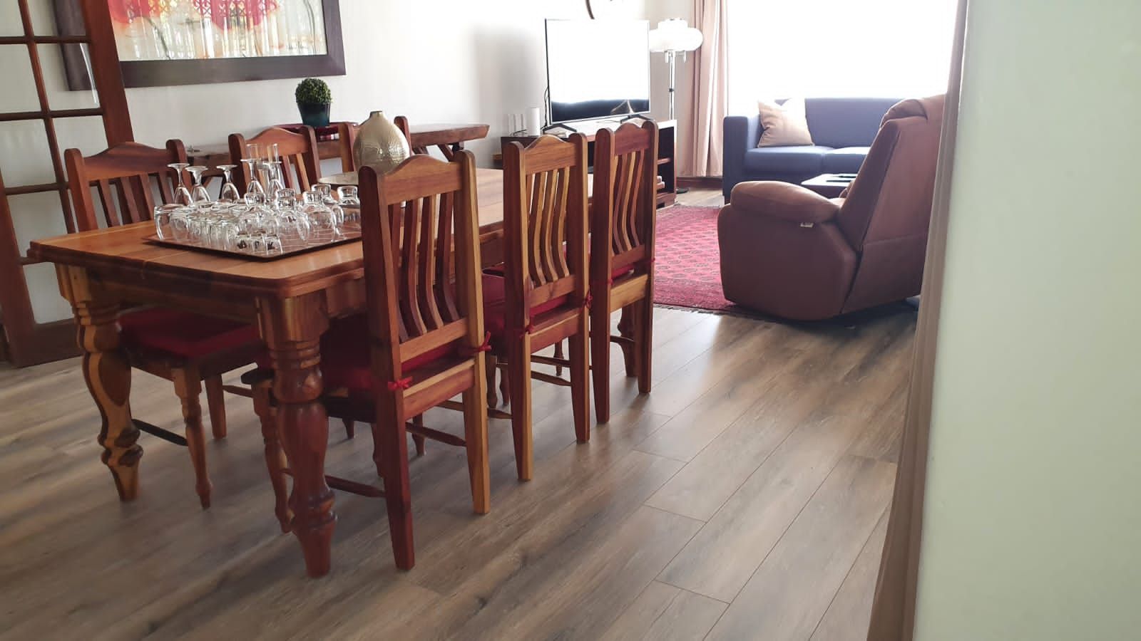 A dining room table and chairs in a living room