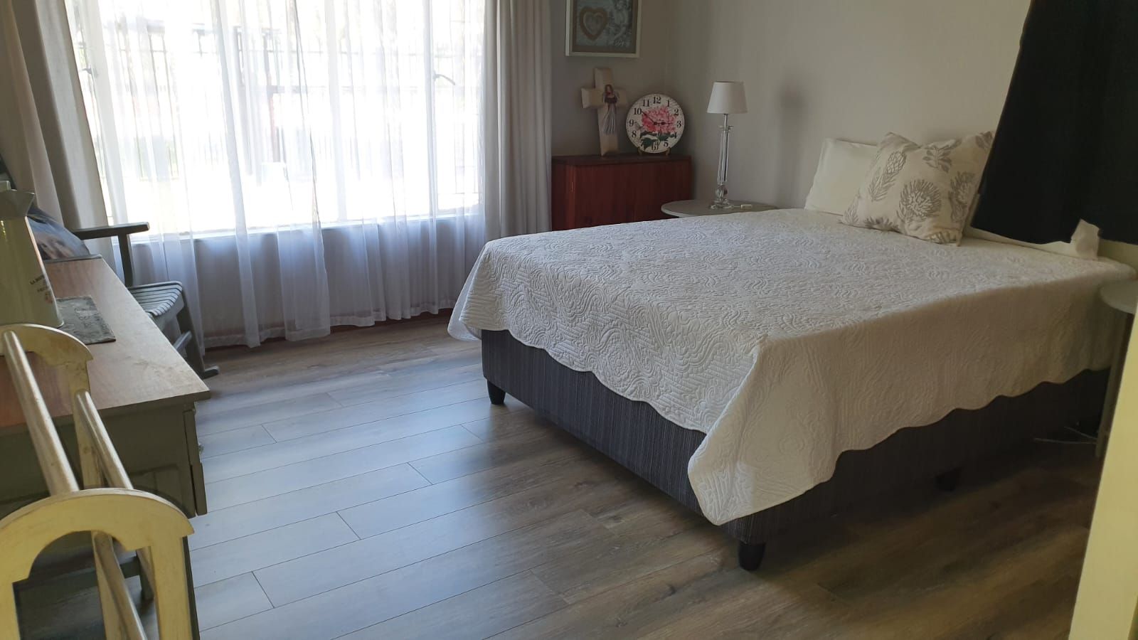 A bedroom with a large bed and a window.