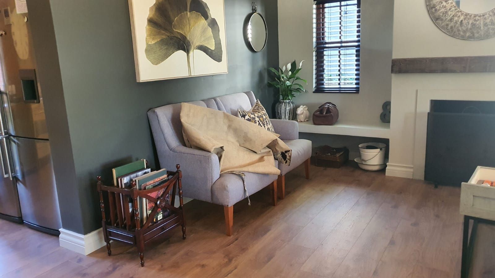 A living room with a couch and chairs and a fireplace.