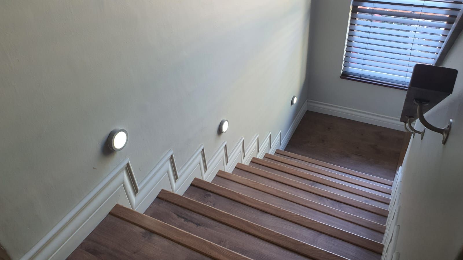 A set of wooden stairs leading up to the second floor of a house.