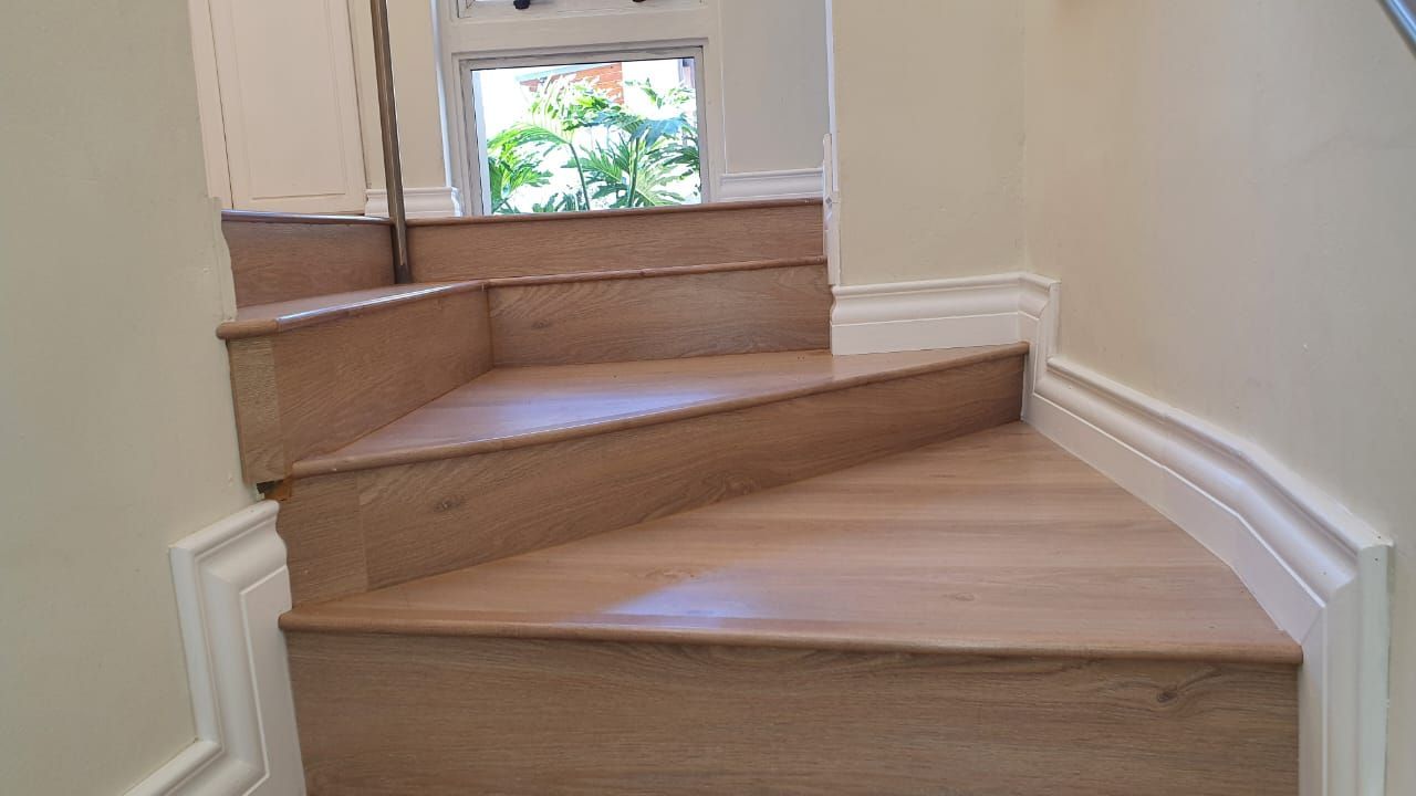 A set of wooden stairs leading up to the second floor of a house.