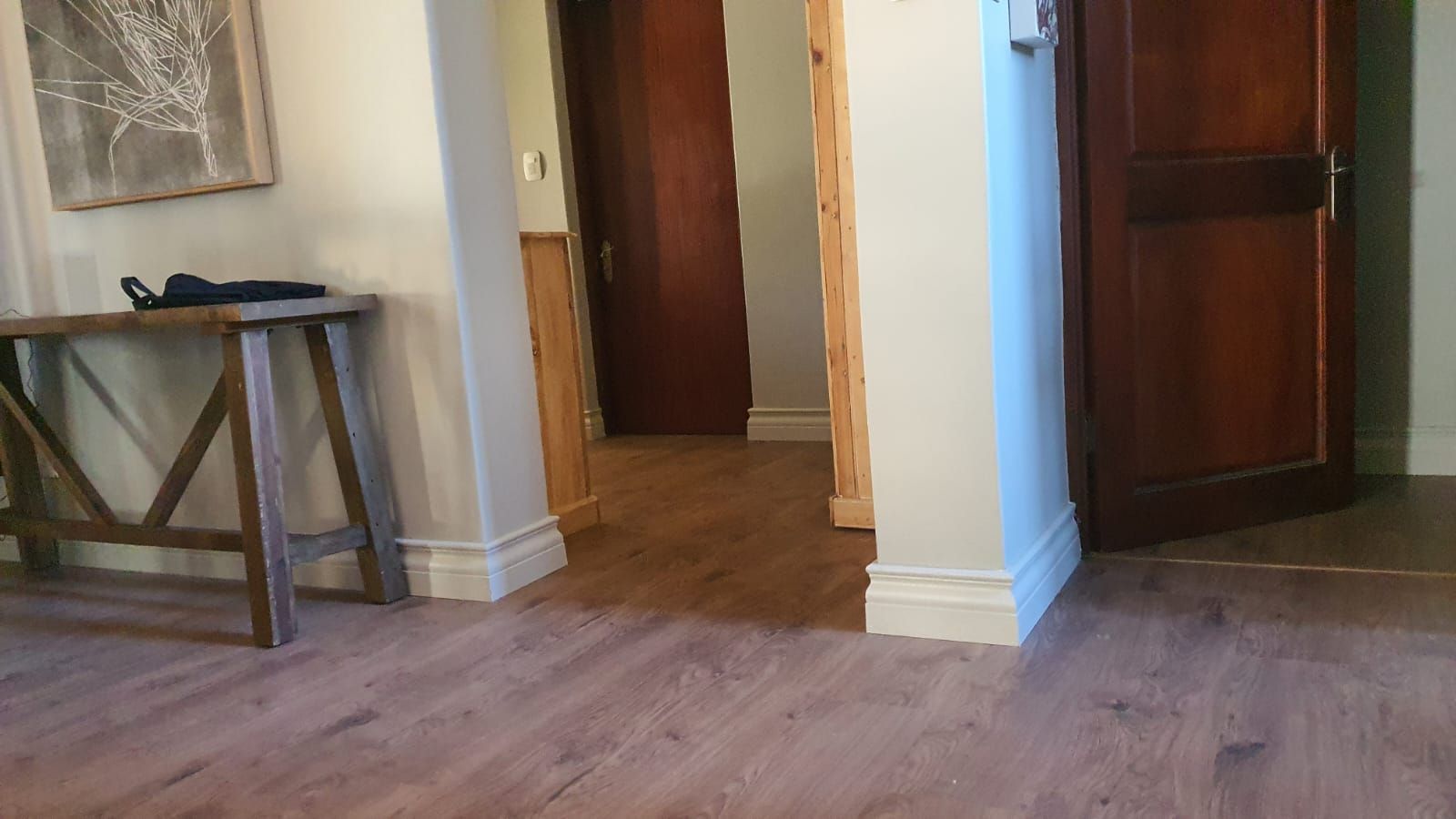 There is a wooden table in the middle of the room.