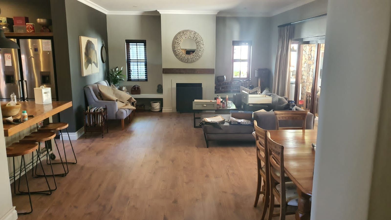 A living room with hardwood floors and a fireplace