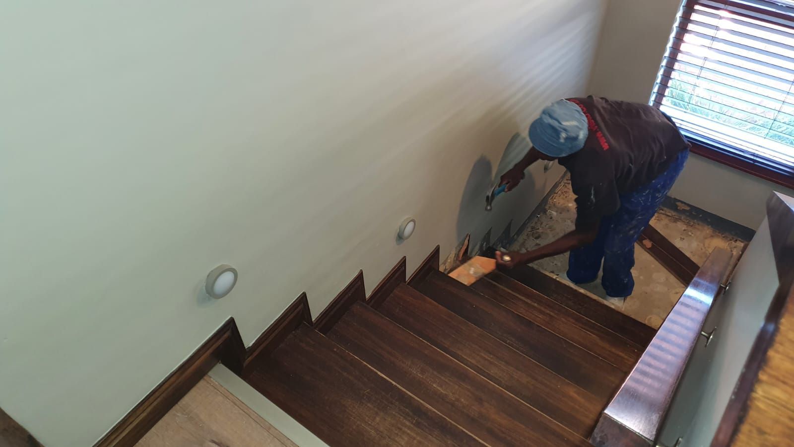 A man is standing on a set of wooden stairs.