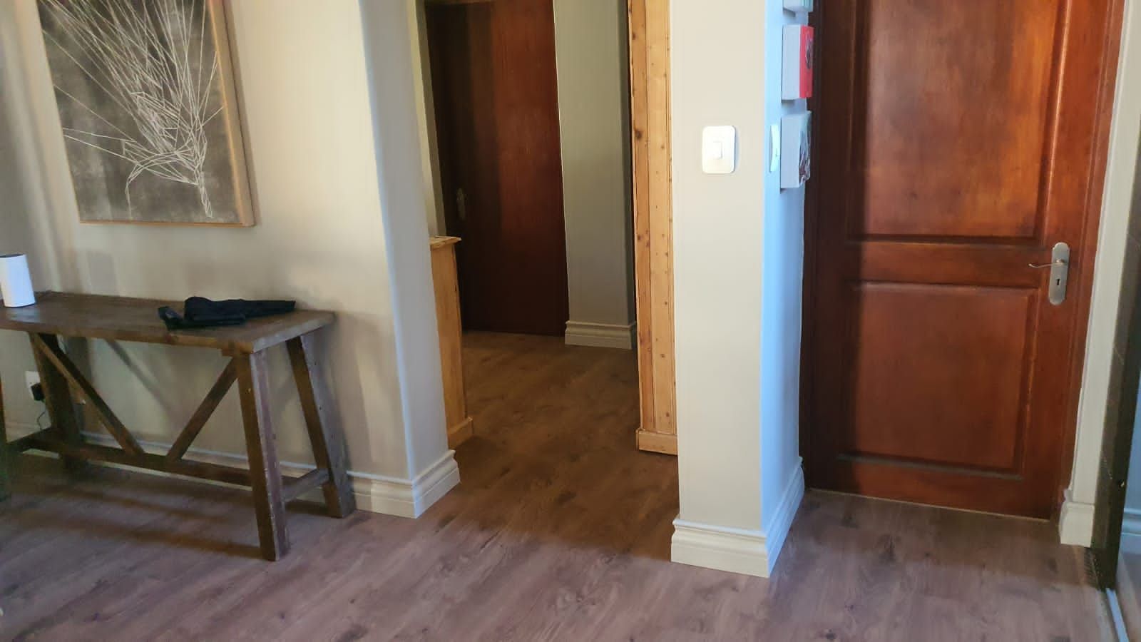 There is a wooden table in the middle of the room.