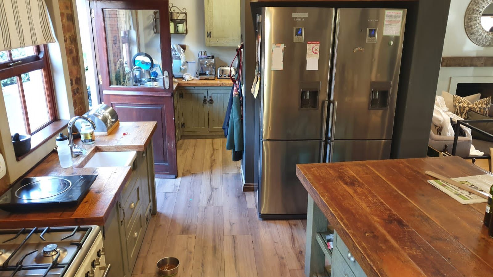 A kitchen with stainless steel appliances and a wooden counter top.