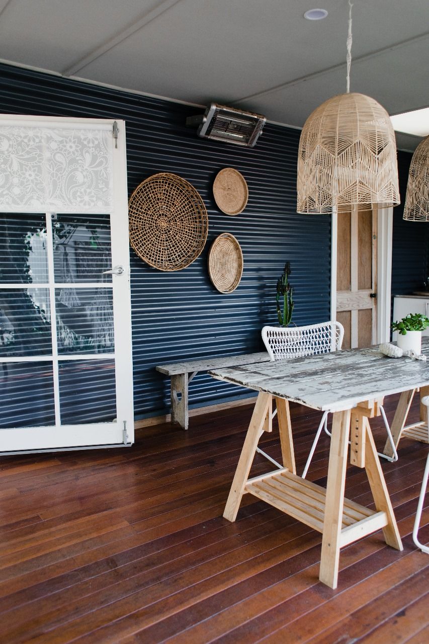 A wooden table and chairs in a room with a blue wall.
