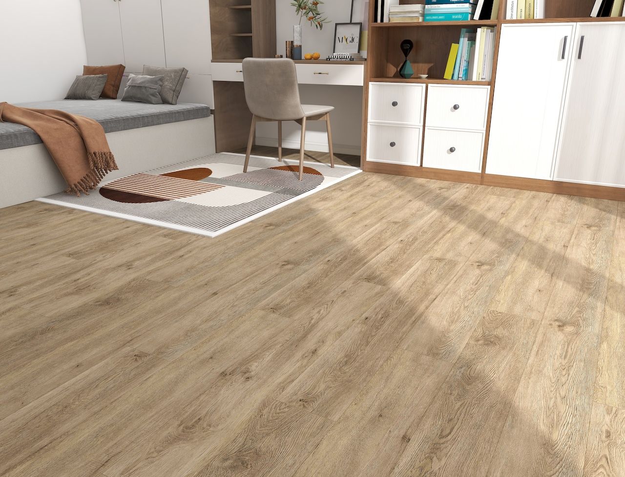 A bedroom with a wooden floor , a bed , a desk , and a rug.