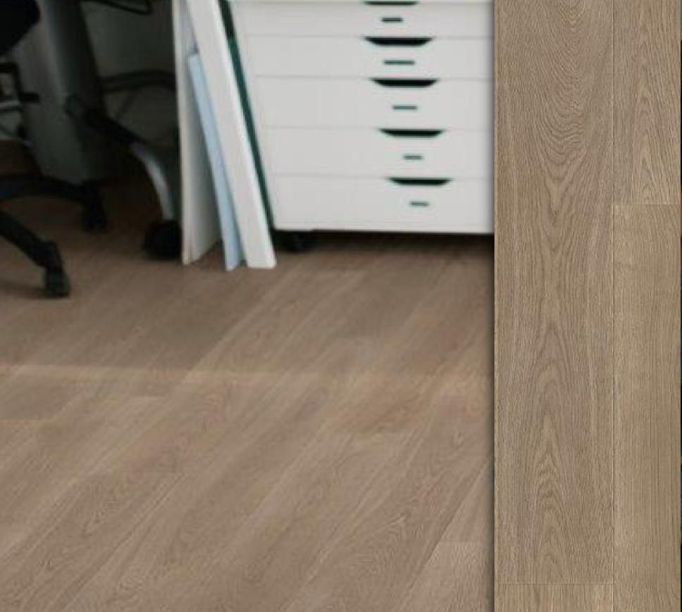 A bedroom with a bed and a kitchen in a small apartment.