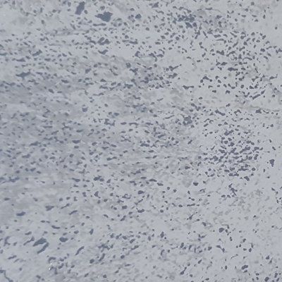 A close up of a white surface with a lot of small dots on it.