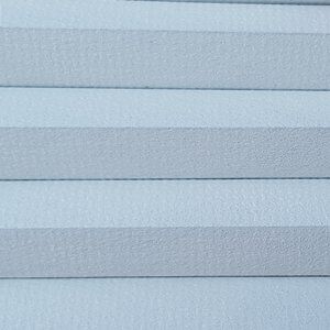 A close up of a pleated blind on a window.