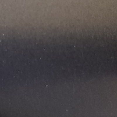 A close up of a black surface with a lot of dust on it.