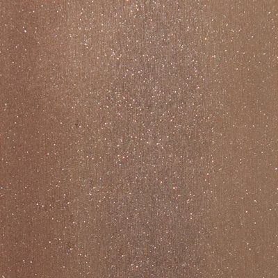 A close up of a brown surface with glitter on it.