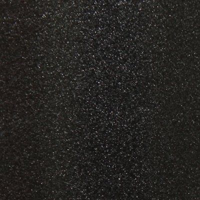 A close up of a black surface with white dots