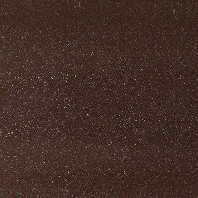 A close up of a brown surface with white dots on it.