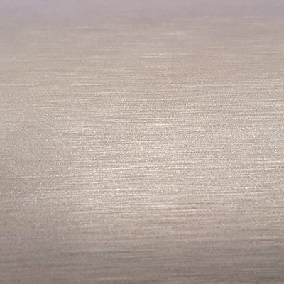 A close up of a piece of stainless steel with a brushed finish.