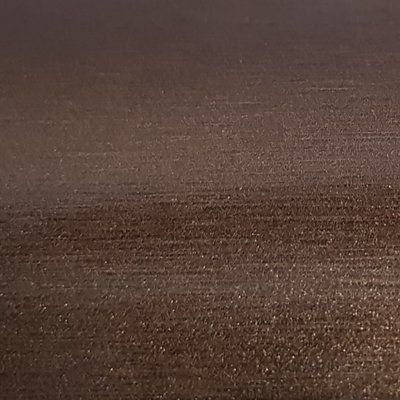 A close up of a brown surface with a grainy texture.