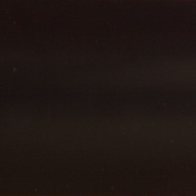 A close up of a black background with a few white spots on it.