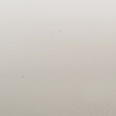 A close up of a white surface with a grainy texture.