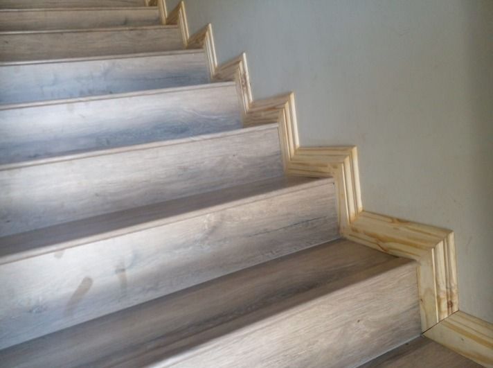A staircase with wooden steps and a wooden railing.