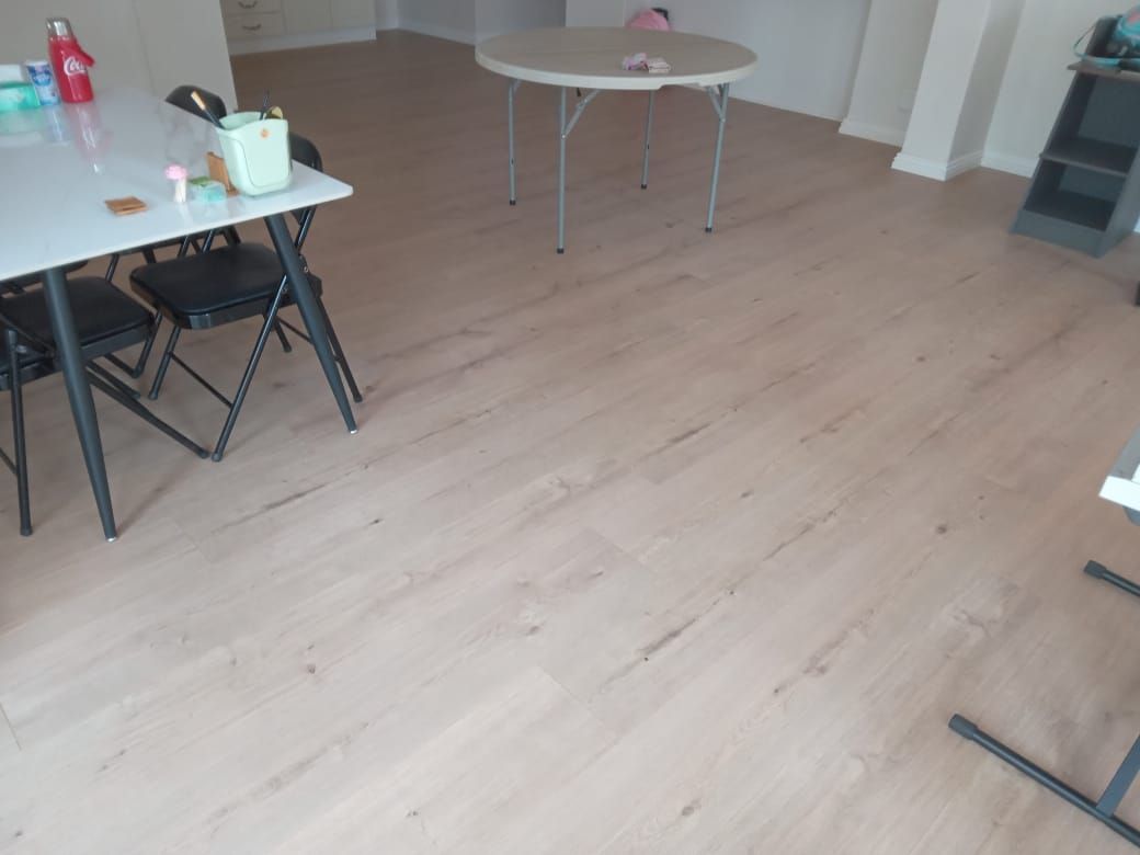 A room with a table and chairs on the floor