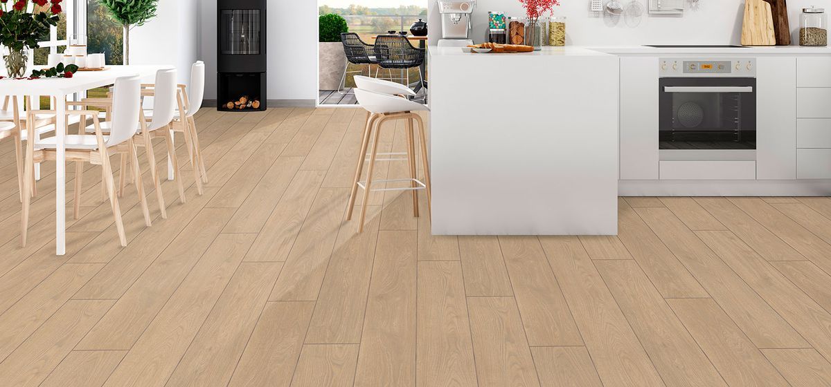 A kitchen with a wooden floor and white cabinets.