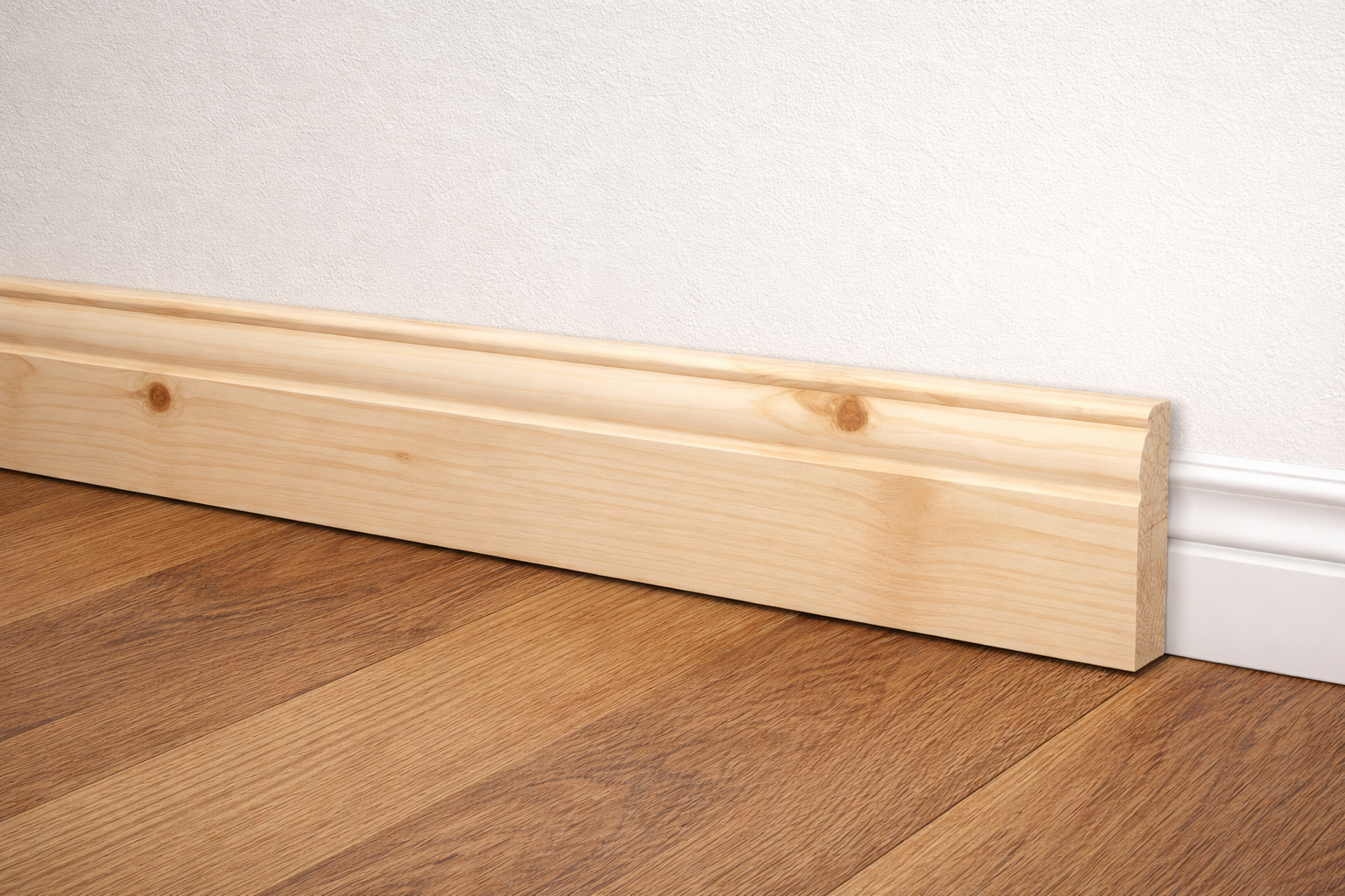 Pine skirting board fitted along a wall with wood flooring in a modern interior
