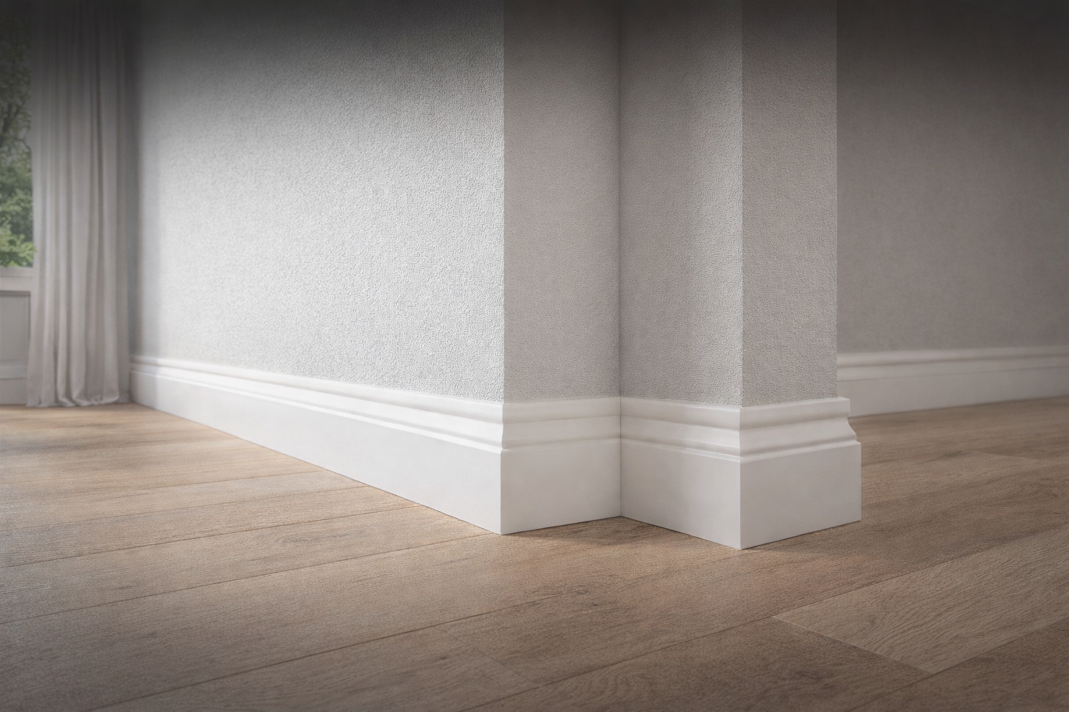 Wooden skirting boards installed in a room with laminate flooring showing clean white skirting