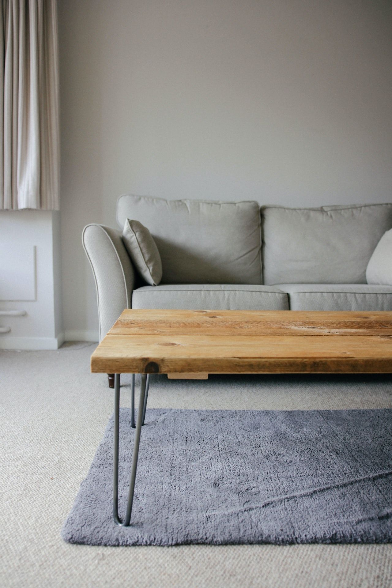 A living room with a couch , coffee table , and rug.