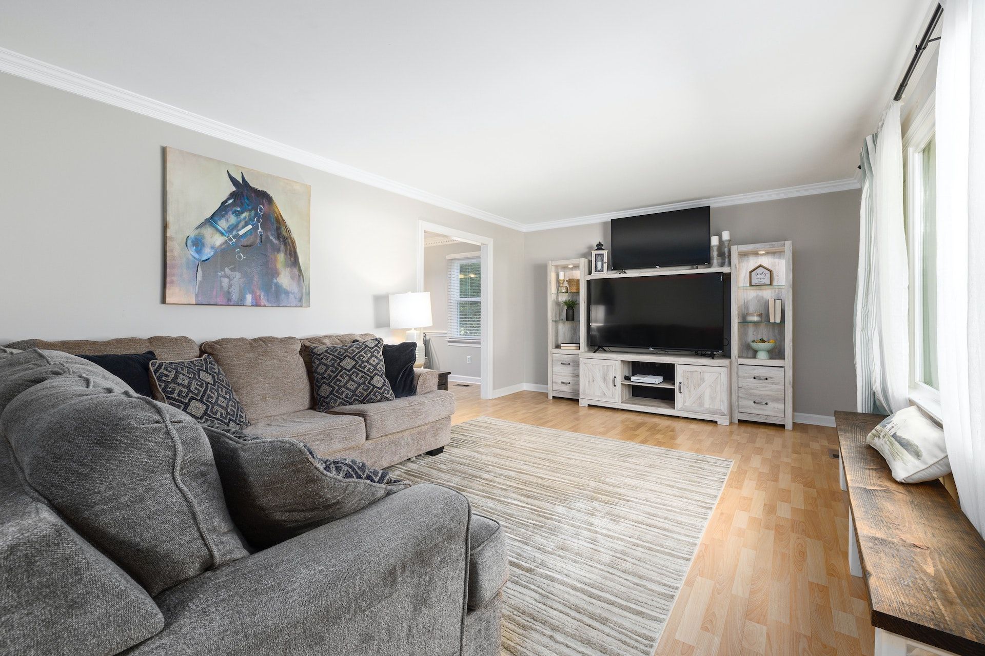 A living room with a couch , chair , and television.