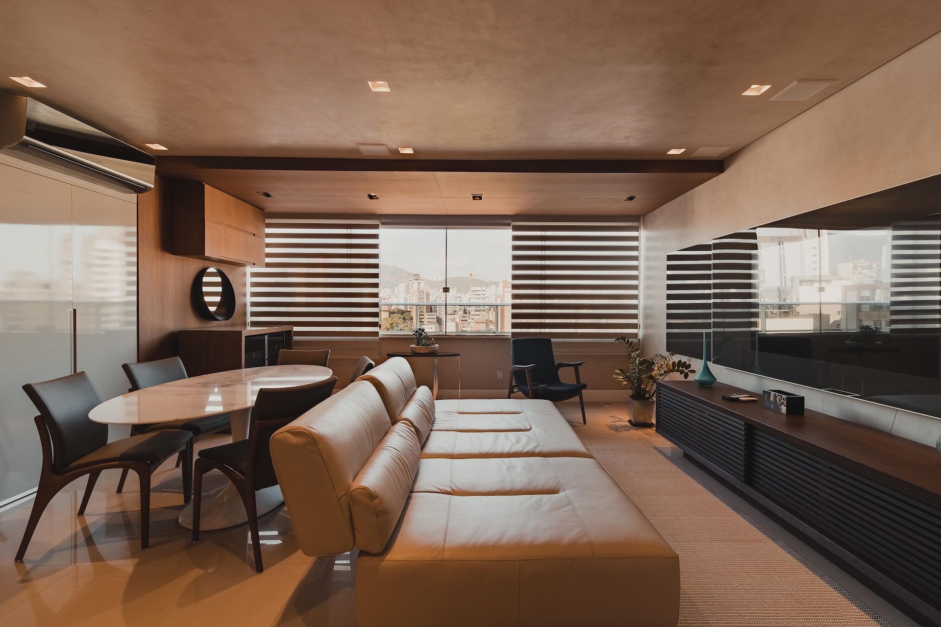 A living room with a couch , table and chairs.