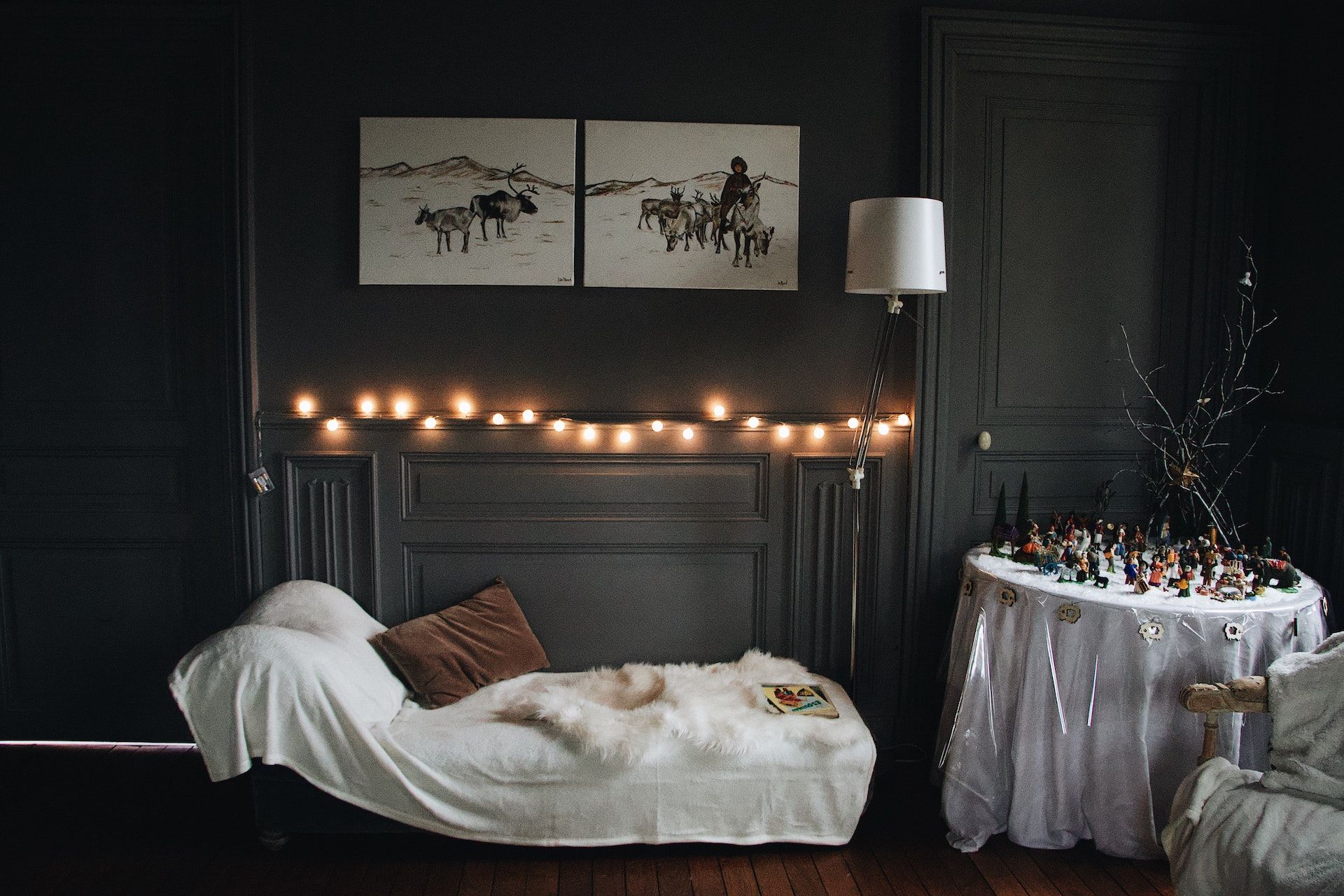 A couch is sitting in a dark room next to a table.