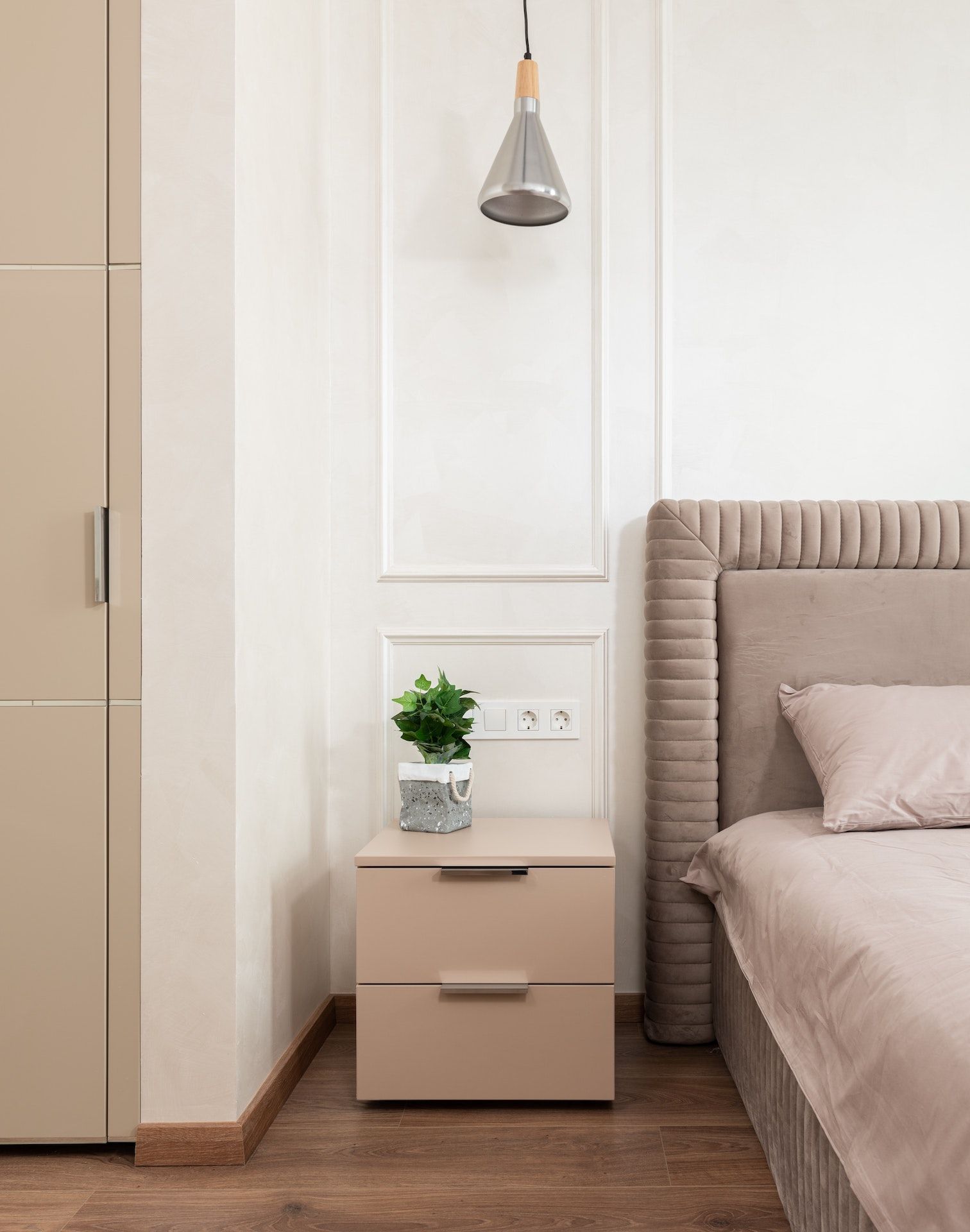 A bedroom with a bed and a nightstand next to it.