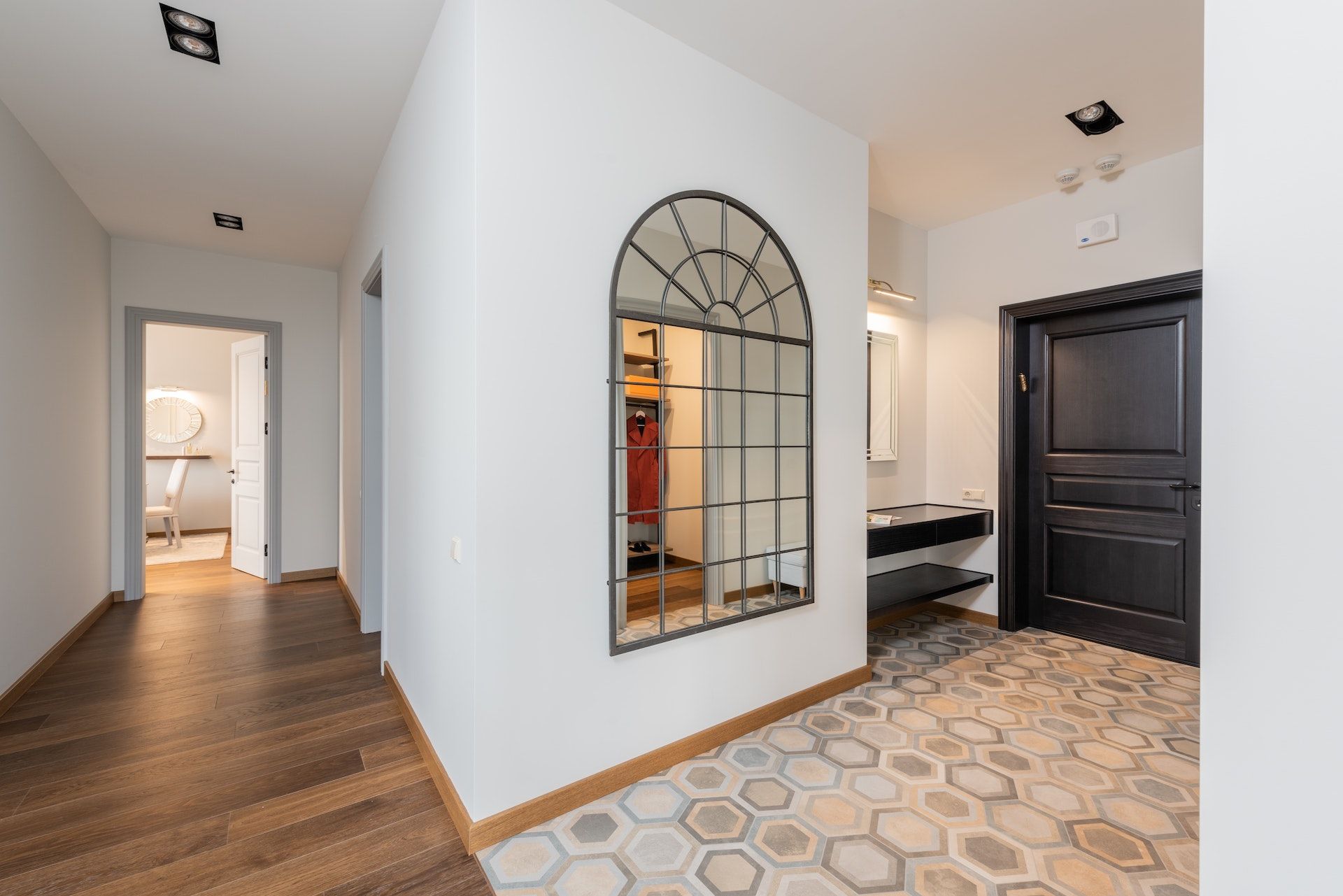 A hallway with a large mirror on the wall.