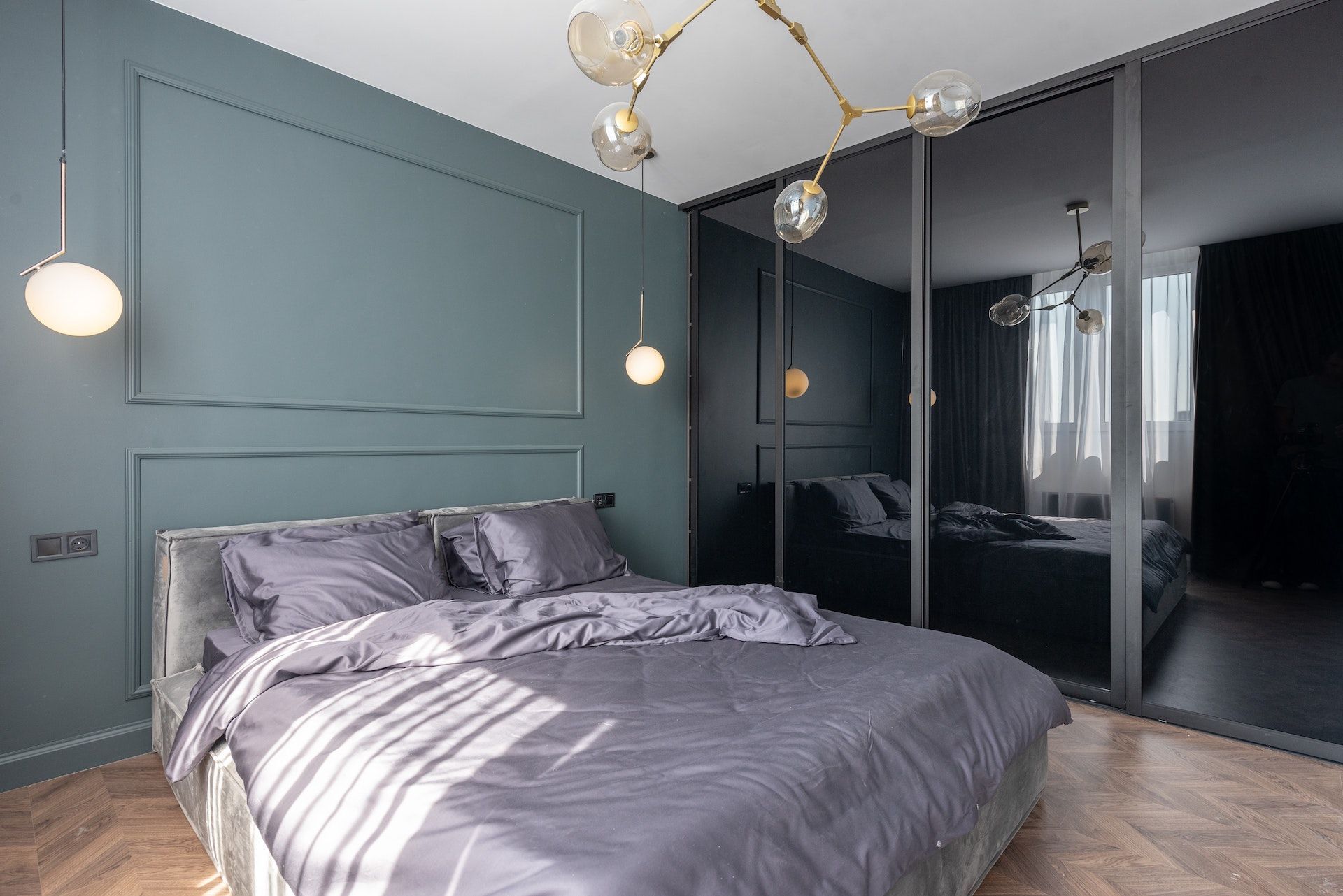 A bedroom with a large bed and a sliding glass door.