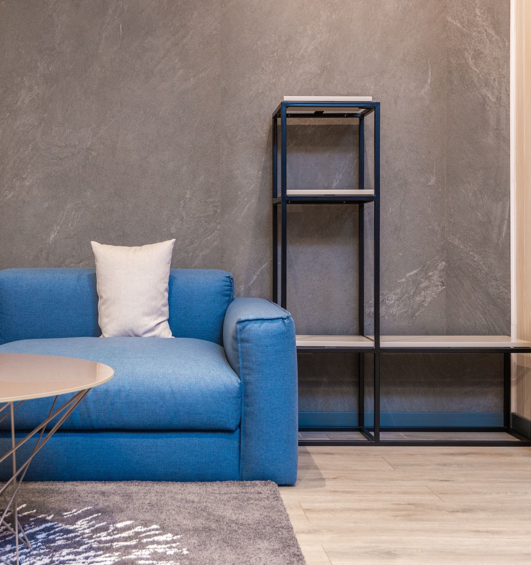 A living room with a blue couch and a coffee table