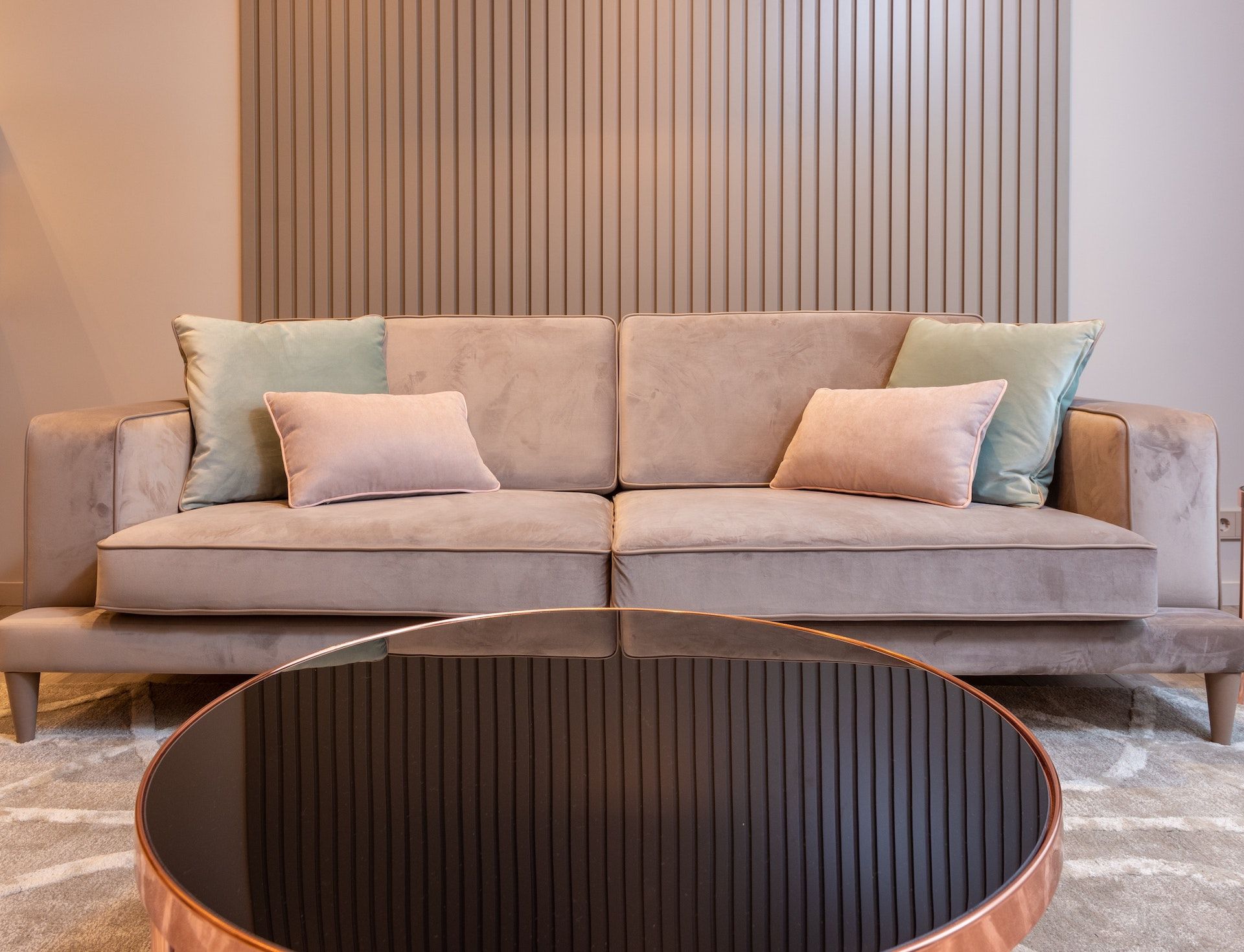 A living room with a couch and a round coffee table.