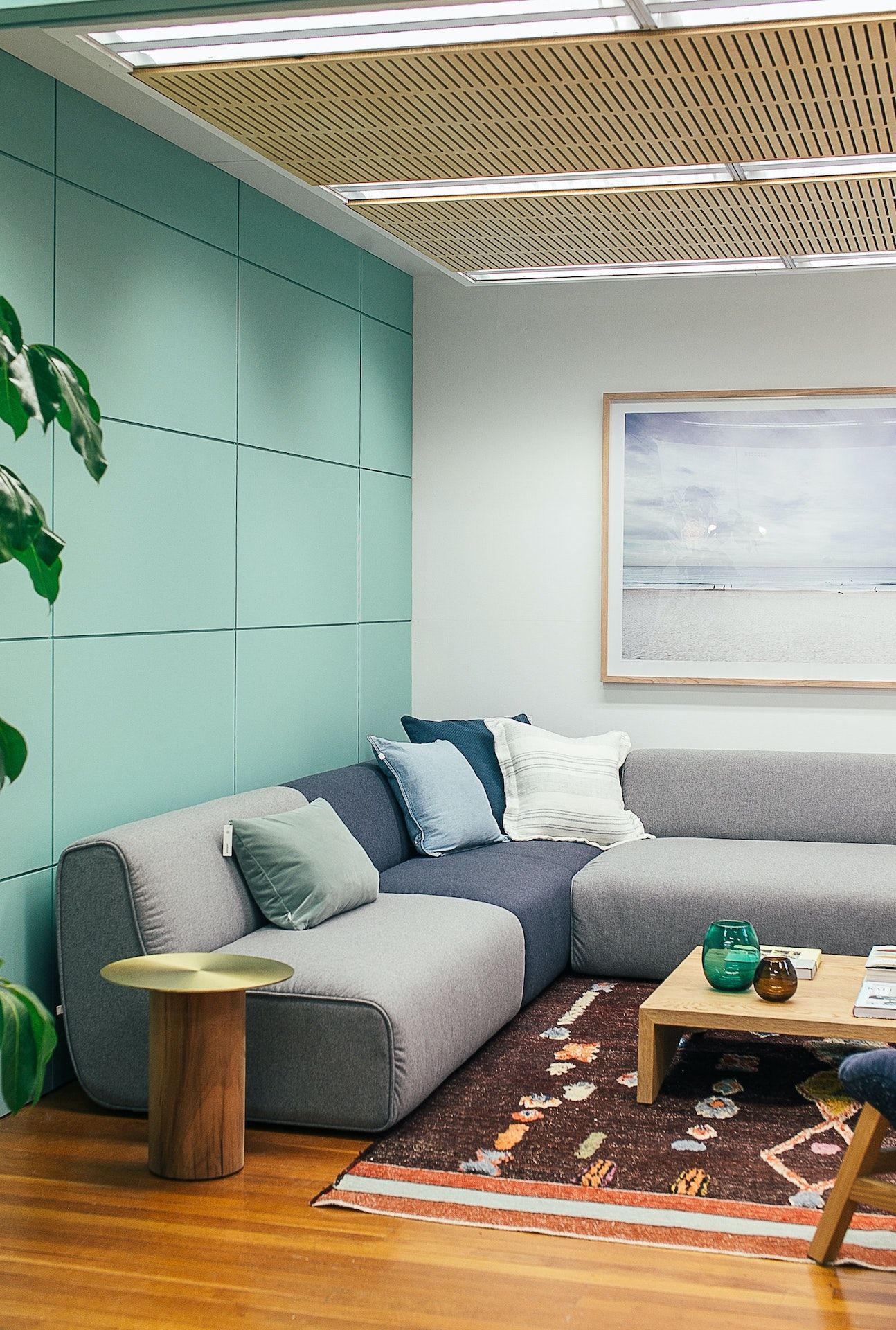A living room with a couch , coffee table , and a picture on the wall.