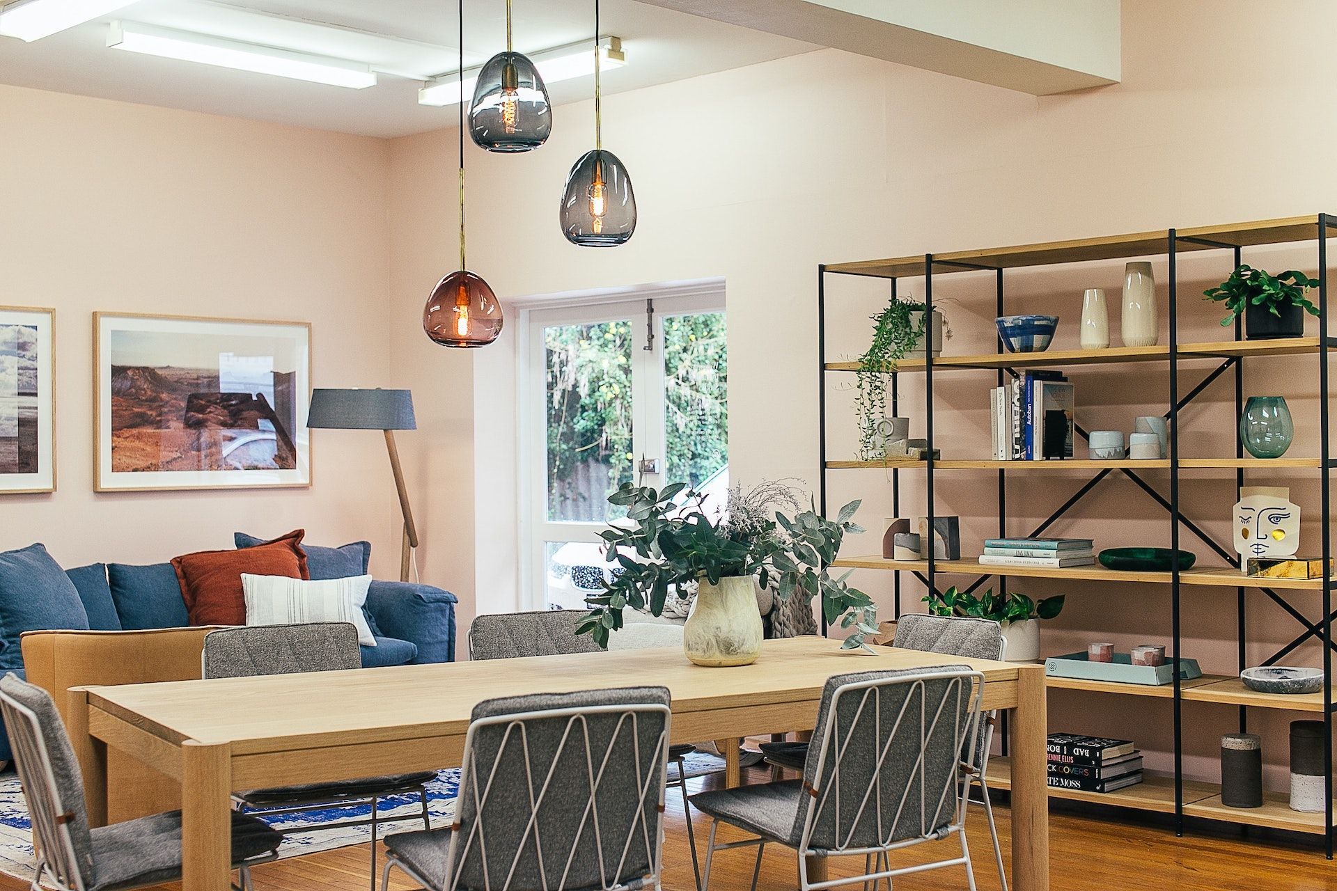 A living room with a table and chairs and a couch.