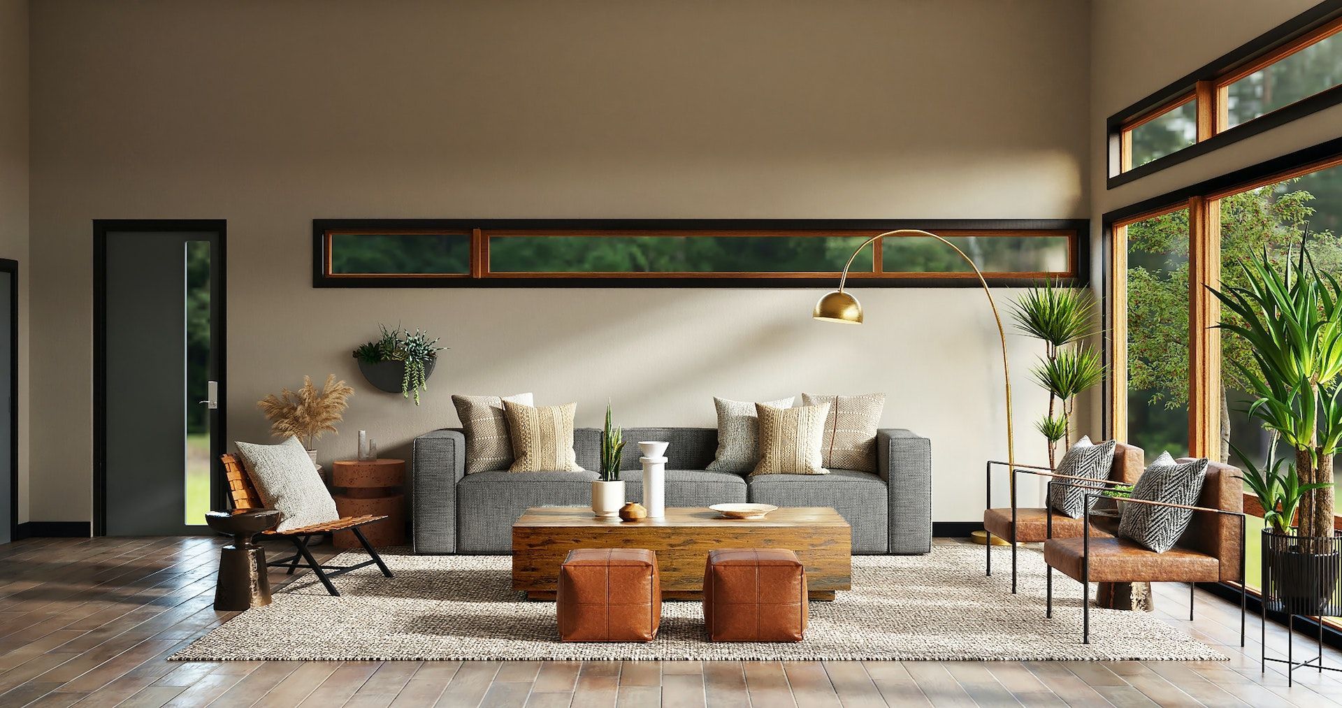 A living room with a couch , coffee table , chairs and lots of windows.