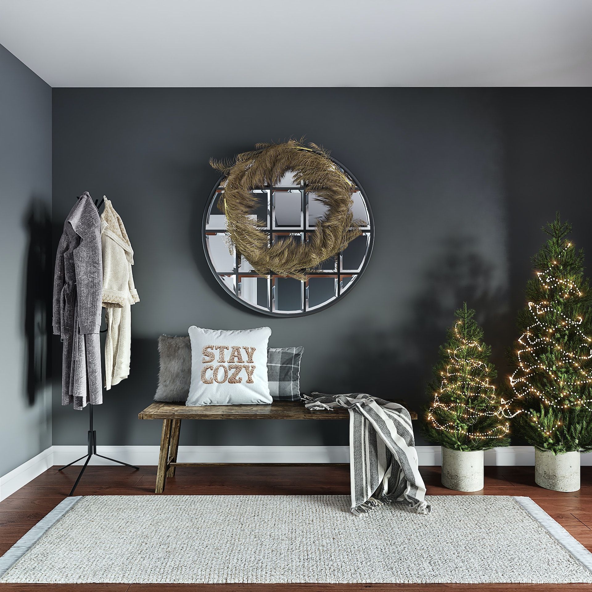 A room with two christmas trees and a pillow that says stay cozy