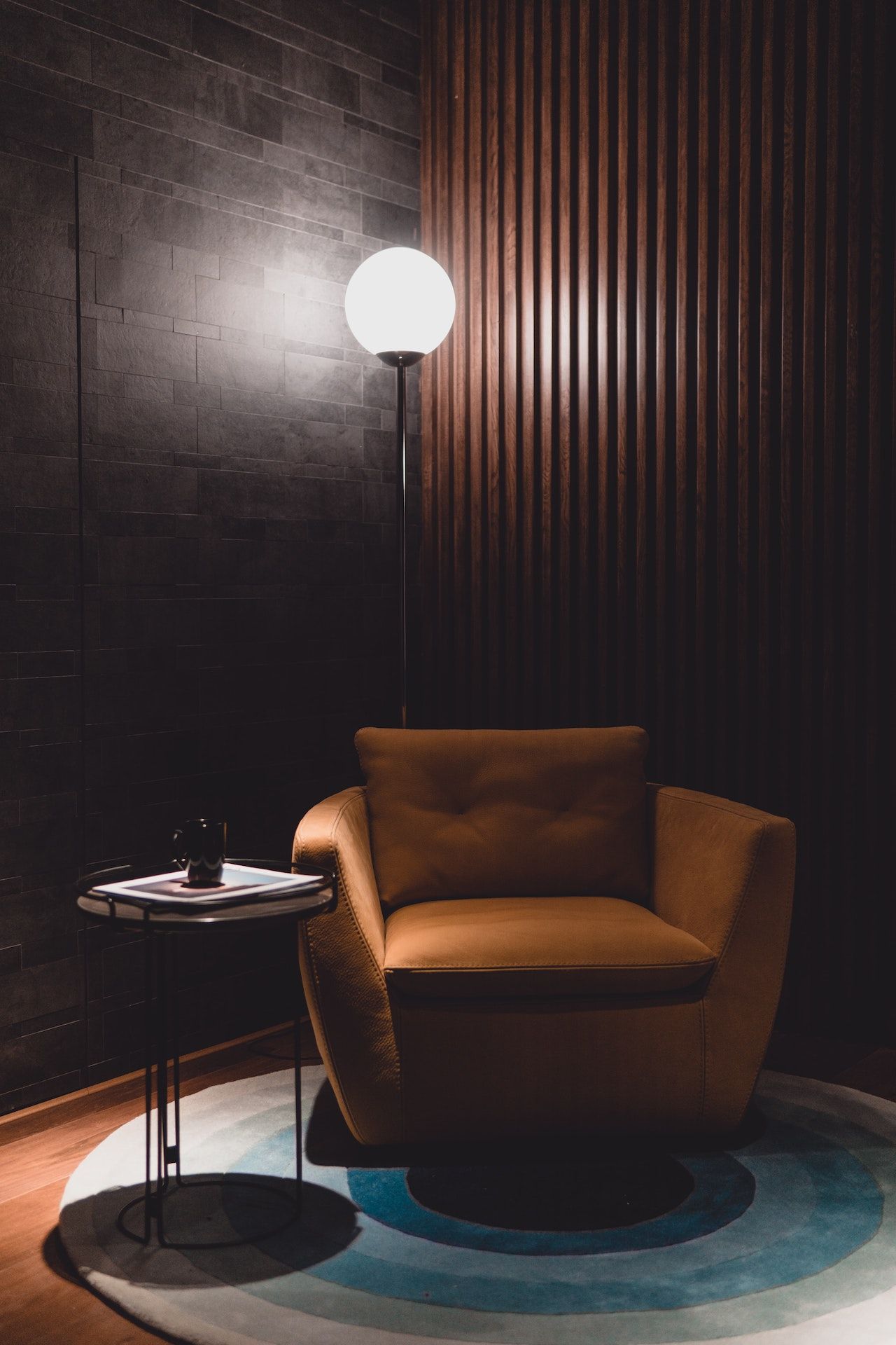 There is a chair and a lamp in the room.