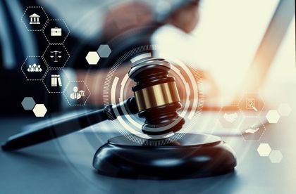a judge 's gavel is sitting on a table in front of a laptop computer