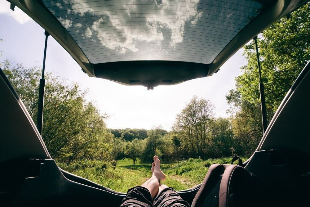 A Person Is Laying in The Back of A Car with Their Feet Up — Strut Re-gas Mackay In Ooralea, QLD