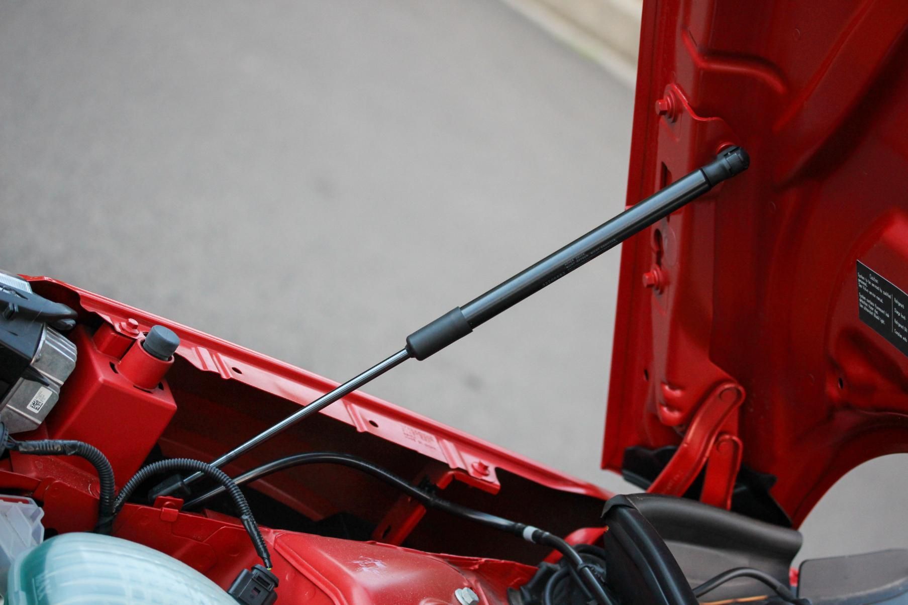 A Red Car With the Hood Open and a Black Gas Strut — Strut Re-gas Mackay In Ooralea, QLD
