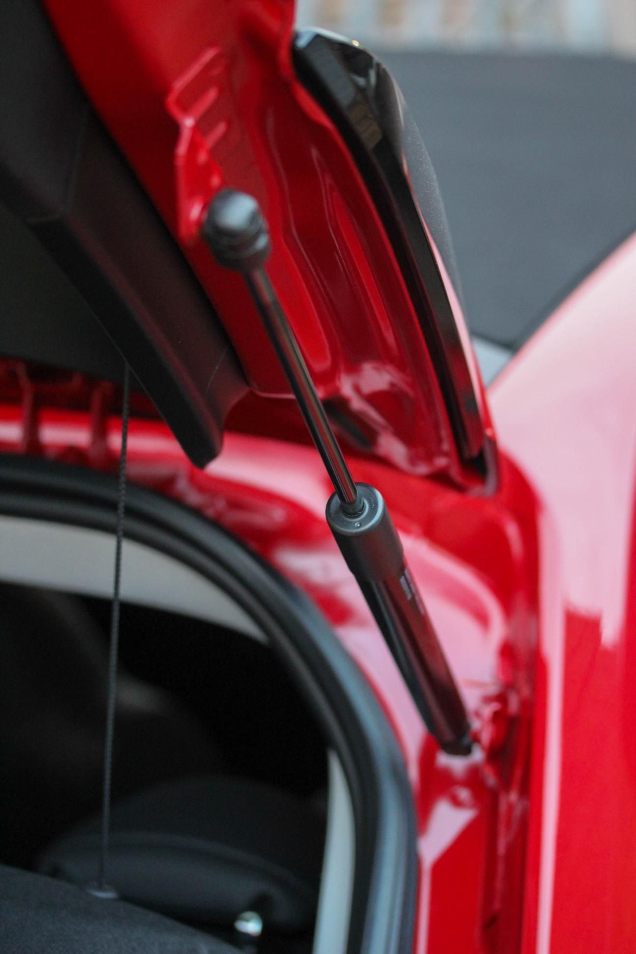 A Red Car With the Trunk Open and a Black Gas Spring — Strut Re-gas Mackay In Ooralea, QLD