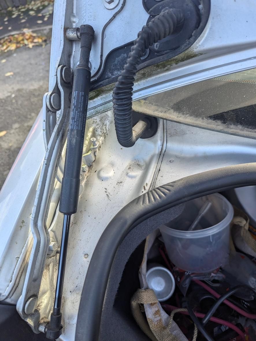 A Close Up of a Car Trunk With a Hose Coming Out of It — Strut Re-gas Mackay In Ooralea, QLD
