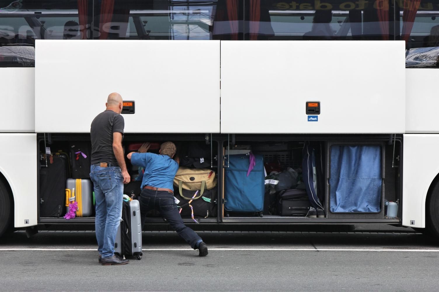 Two Men Are Loading Luggage Into the Back of a Bus — Strut Re-gas Mackay In Ooralea, QLD